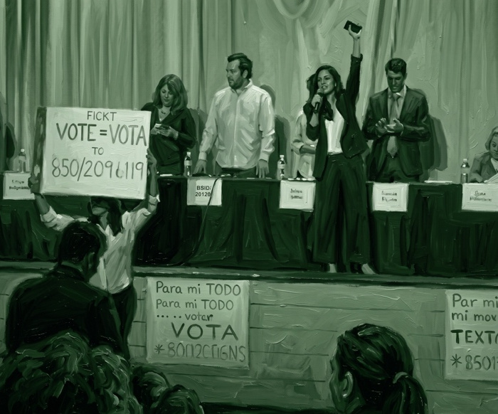 A school board candidate forum, with a parent in the audience holding up a Vote = Vota sign